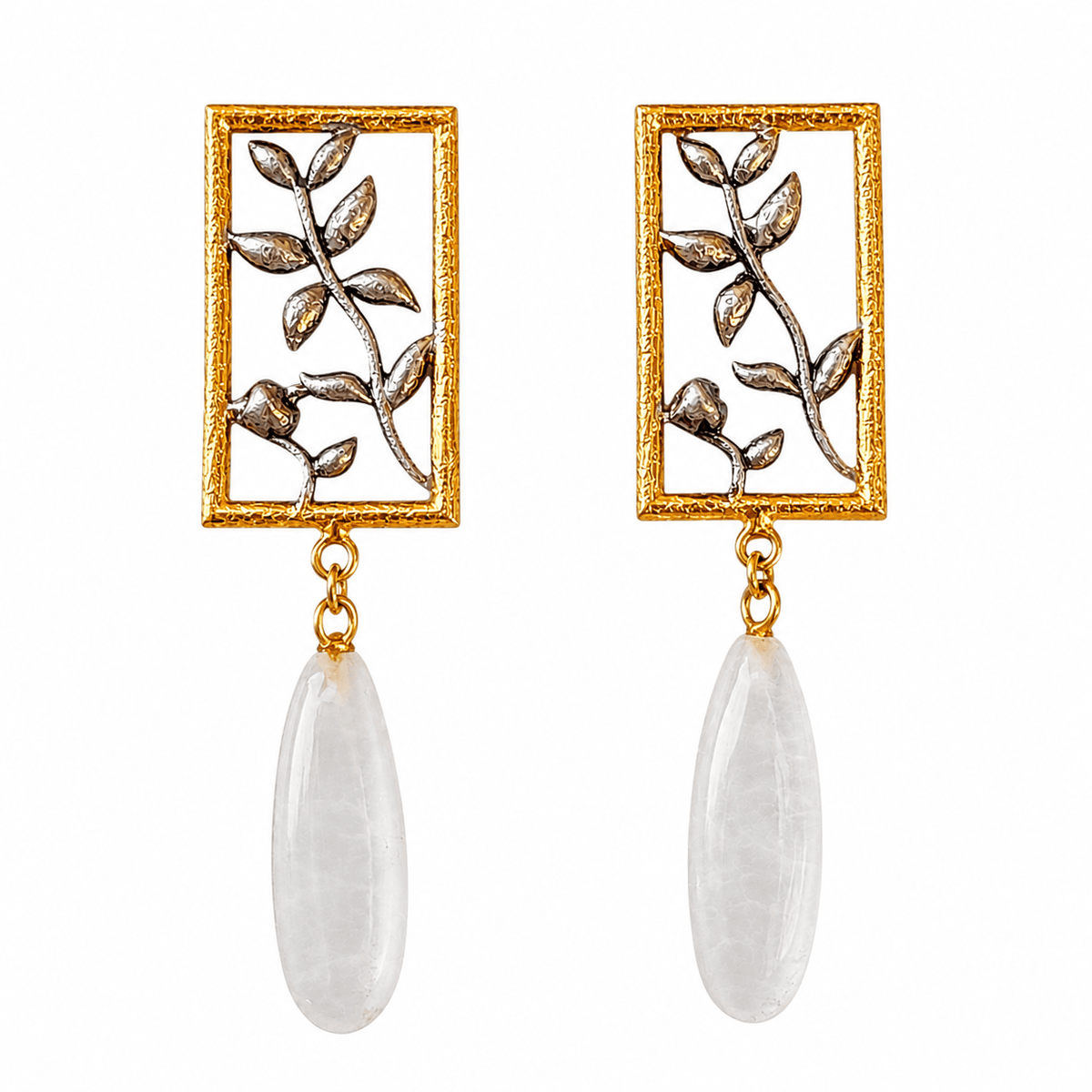 BEL earrings with gold-tone rectangular frames, silver-tone botanical vines and elongated white stone drops on white.