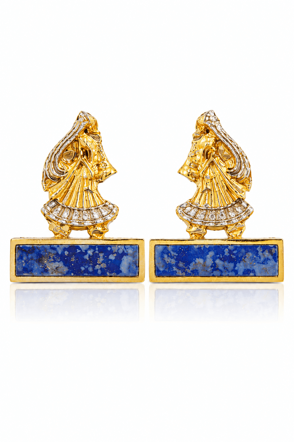 Close-up of Modern Maharani earrings showing sculpted gold-tone figures, silver-tone accents and blue lapis bars on white.