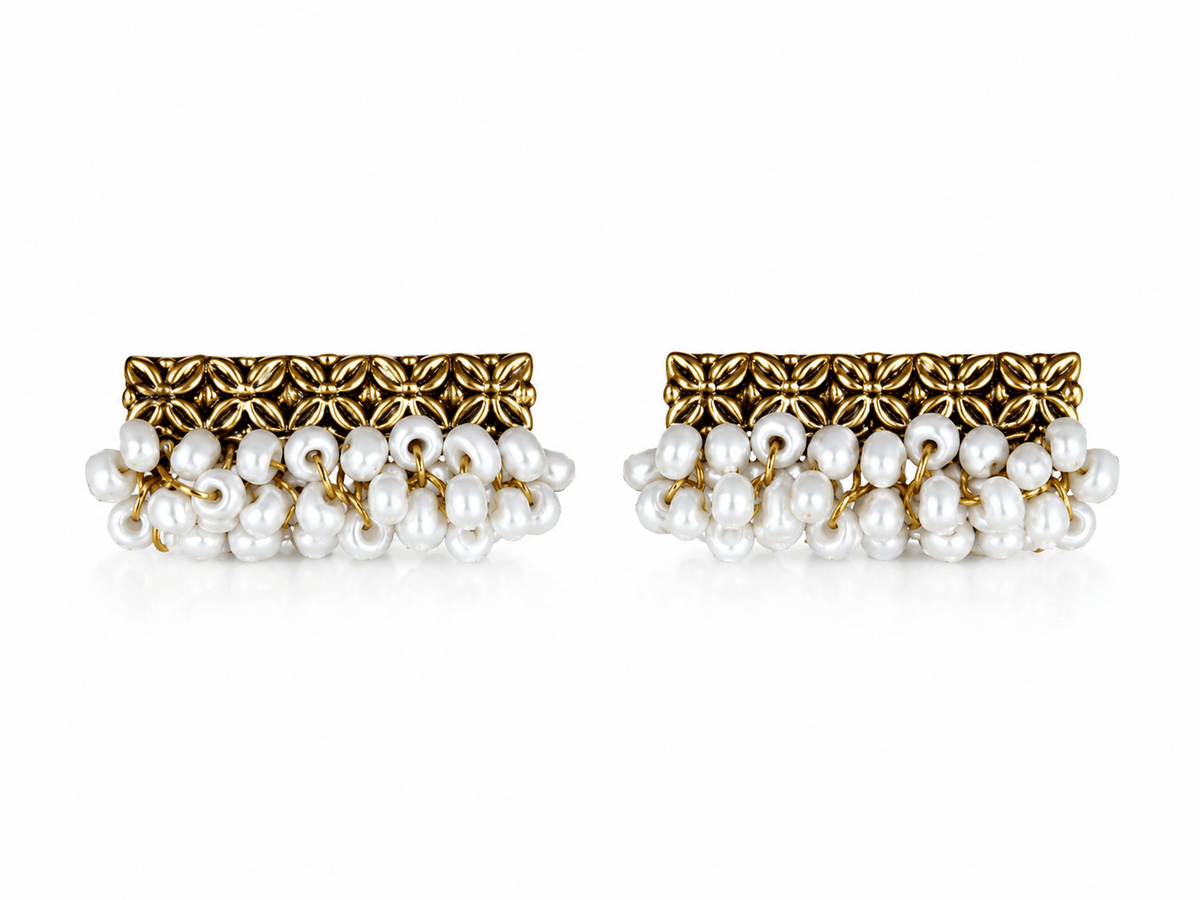 Piroyi Pearl Earrings with gold-tone floral bars and hand-woven clusters of white pearl drops, displayed on a white background.