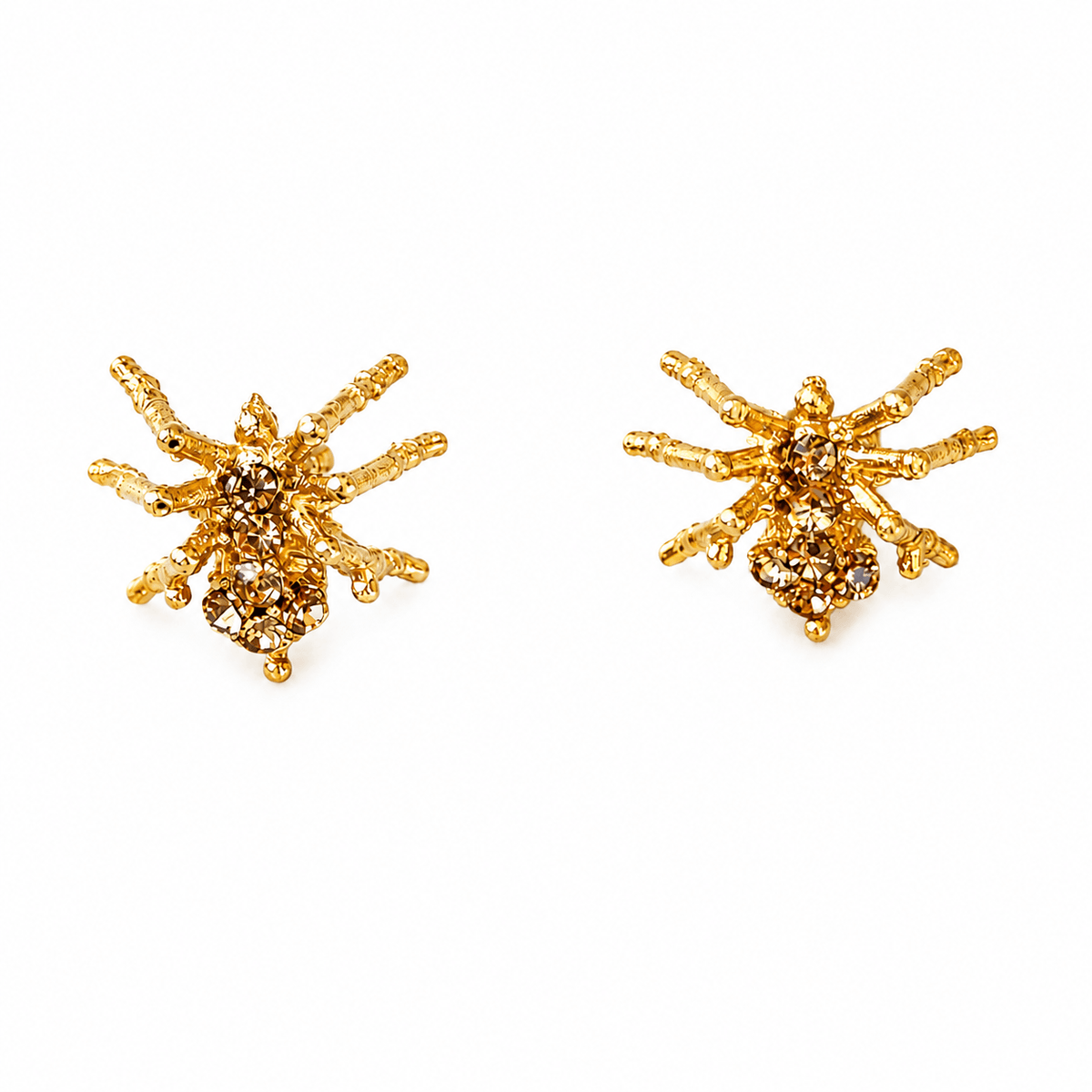Front view of Spider Studs earrings showing textured gold-tone legs and sparkling stone-set bodies on a white background.